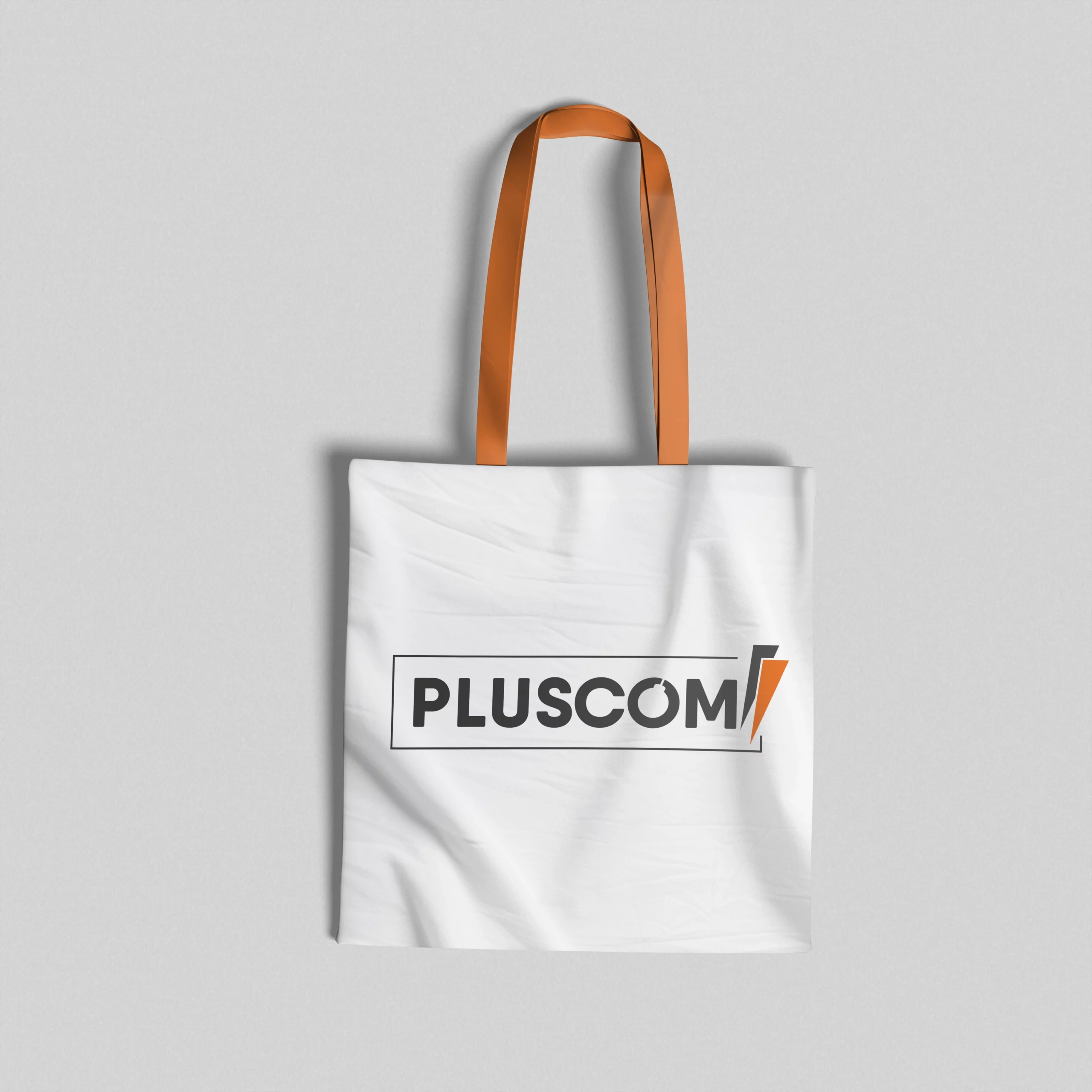 Sac totebag blanc imprimé PLUSCOM – Branding agence de communication Aytré
